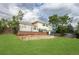 Expansive backyard featuring a deck, lush lawn, and mature trees for outdoor enjoyment at 1775 S Memphis St, Aurora, CO 80017