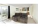 Finished basement with comfortable seating, walkout access, and bright natural light at 1775 S Memphis St, Aurora, CO 80017