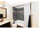 Cozy bathroom featuring a tub with shower, tile surround, and a sleek vanity at 1775 S Memphis St, Aurora, CO 80017
