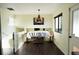 Cozy dining area with modern light fixture, art piece, and bright window view at 1775 S Memphis St, Aurora, CO 80017