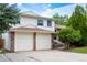 Beautiful residence displaying a two-car garage, mature evergreens, and a landscaped yard at 1775 S Memphis St, Aurora, CO 80017
