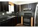 Stylish kitchen with dark cabinets, mosaic backsplash, and efficient layout at 1775 S Memphis St, Aurora, CO 80017