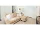 Inviting living area featuring a cozy sofa, carpeted floors, and natural light at 1775 S Memphis St, Aurora, CO 80017