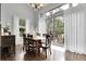 Dining room featuring large windows and access to the backyard deck at 171 Columbine St, Larkspur, CO 80118