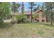 Beautiful single-Gathering home with mature landscaping, a circular driveway, and a well-maintained lawn at 171 Columbine St, Larkspur, CO 80118