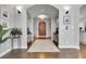 Grand foyer with arched doorway, hardwood floors, decorative rug, and elegant light fixtures at 171 Columbine St, Larkspur, CO 80118
