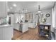 Spacious kitchen with white cabinetry, granite countertops, and a dining area with natural light at 171 Columbine St, Larkspur, CO 80118