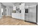 Bright kitchen features white cabinets, stainless steel refrigerator, and wood flooring at 171 Columbine St, Larkspur, CO 80118