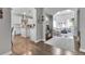 Open-concept living room and kitchen with hardwood floors, white cabinets, and modern appliances at 171 Columbine St, Larkspur, CO 80118