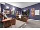Cozy theater room with reclining leather chairs, movie posters, and a large screen TV at 171 Columbine St, Larkspur, CO 80118
