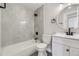 Newly renovated bathroom featuring white tile, modern black fixtures, and sleek vanity at 15689 E Eastman Pl, Aurora, CO 80013