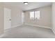 Bright bedroom with neutral walls, carpet flooring, and a window overlooking a tree at 15689 E Eastman Pl, Aurora, CO 80013