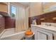 Bathroom featuring a white tub, toilet, sink, and tile in an older home at 1665 S Madison St, Denver, CO 80210