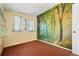 This bedroom includes a scenic forest mural and a window for natural light at 1665 S Madison St, Denver, CO 80210