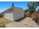 Exterior view of the home's garage and backyard with wooden fence at 1665 S Madison St, Denver, CO 80210