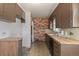 Side view of a vintage kitchen with wood countertops and unique brick wall design at 1665 S Madison St, Denver, CO 80210