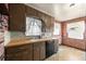Classic kitchen with brown cabinets, brick walls, and a vintage tile backsplash at 1665 S Madison St, Denver, CO 80210