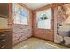 Angle view of the kitchen featuring brick walls, windows, and patterned floors at 1665 S Madison St, Denver, CO 80210