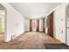 Bright and airy living room featuring neutral walls, carpet, and a window with brown curtains, leading to a front door at 1665 S Madison St, Denver, CO 80210