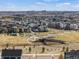 Community aerial view featuring a park, walking trails, green spaces, and diverse housing options with city views at 5511 Wabash St, Denver, CO 80238