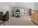 Spacious carpeted basement featuring a home gym, an office area, and an entryway to the home's upper level at 5511 Wabash St, Denver, CO 80238