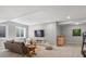 Finished basement showcasing neutral walls, plush carpet, and a cozy seating area with a large-screen television at 5511 Wabash St, Denver, CO 80238