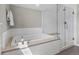 The spacious bathroom features a soaking tub with a walk-in glass shower at 5511 Wabash St, Denver, CO 80238