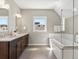 This bathroom features a tub, shower, and double vanity with white countertops at 5511 Wabash St, Denver, CO 80238