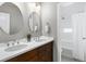 Bathroom featuring a double vanity with a door leading to the shower and bathtub at 5511 Wabash St, Denver, CO 80238