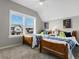 This bedroom features two beds, a ceiling fan, and a bright sunny window at 5511 Wabash St, Denver, CO 80238