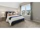 This bedroom features a large window and grey curtains with neighborhood views at 5511 Wabash St, Denver, CO 80238