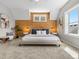 This spacious bedroom boasts a wood accent wall, a ceiling fan, and two windows at 5511 Wabash St, Denver, CO 80238