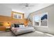 This bedroom features a wood accent wall and lots of natural light coming through the windows at 5511 Wabash St, Denver, CO 80238