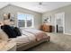 This bedroom features large windows and an ensuite bathroom with an open doorway at 5511 Wabash St, Denver, CO 80238