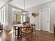Bright dining area with modern lighting and access to outdoor patio at 5511 Wabash St, Denver, CO 80238