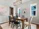 Cozy dining room showcasing a wooden table, modern lighting, and large windows at 5511 Wabash St, Denver, CO 80238