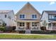 Charming two-story home with a welcoming front porch and manicured lawn at 5511 Wabash St, Denver, CO 80238