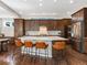 Spacious kitchen featuring custom cabinets, stainless appliances, and eat in bar at 5511 Wabash St, Denver, CO 80238