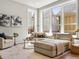 Bright living area with large windows, a comfortable sectional, and elegant decor at 5511 Wabash St, Denver, CO 80238