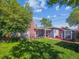 Charming backyard featuring a lush lawn, brick chimney, storage shed, and cozy outdoor seating area at 4112 S Galapago St, Englewood, CO 80110
