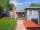 Picturesque backyard featuring a stone paver path and a blue home with brick chimney at 4112 S Galapago St, Englewood, CO 80110