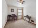 Cozy room with wood paneled walls, a wooden desk and chair, illuminated by natural light at 4112 S Galapago St, Englewood, CO 80110