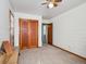 Spacious bedroom with wood paneled walls, and a closet with double doors at 4112 S Galapago St, Englewood, CO 80110