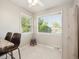 Bright breakfast nook with large windows, featuring a small stool and a modern table and chairs at 4112 S Galapago St, Englewood, CO 80110
