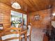 View of dining room, showcasing the wood-paneled walls, fireplace and seamless flow to the living room at 4112 S Galapago St, Englewood, CO 80110