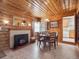 Charming dining room with wood paneling, a cozy fireplace, and room to eat at 4112 S Galapago St, Englewood, CO 80110