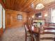 Charming dining room with wood-paneled walls, a cozy fireplace, and stylish decor at 4112 S Galapago St, Englewood, CO 80110