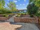 View of front yard, featuring a charming home and steps with a retaining wall at 4112 S Galapago St, Englewood, CO 80110