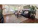 Cozy living room with hardwood floors, large windows, and comfortable leather seating at 4112 S Galapago St, Englewood, CO 80110