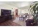 Bright living room featuring hardwood floors, a comfortable sofa, and ample natural light at 4112 S Galapago St, Englewood, CO 80110